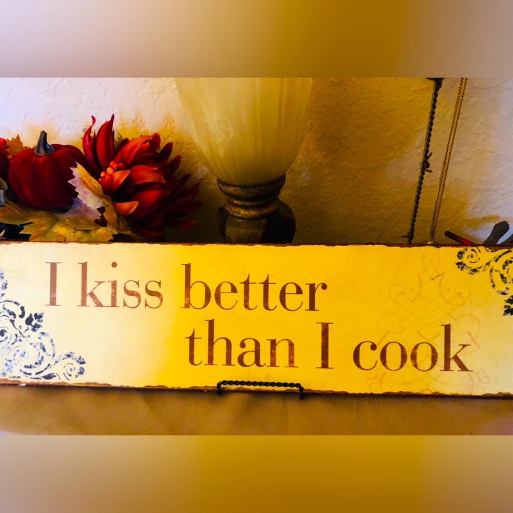 “Kiss Better Than You Cook” 😂 Metal wall decor or display as shown in a stand.